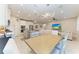 Bright, open kitchen features an island with seating, stainless appliances, and modern lighting at 13228 Saw Palm Creek Trl, Lakewood Ranch, FL 34211