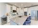 Spacious kitchen with stainless steel appliances, large island, and modern lighting fixtures at 13228 Saw Palm Creek Trl, Lakewood Ranch, FL 34211
