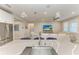 Bright kitchen with stainless steel appliances and a view to the living room at 13228 Saw Palm Creek Trl, Lakewood Ranch, FL 34211