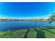 Breathtaking lake view with lush landscaping offers a picturesque setting for this home at 13228 Saw Palm Creek Trl, Lakewood Ranch, FL 34211