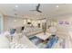 Bright, open-concept living room and kitchen with modern finishes and stylish furnishings at 13228 Saw Palm Creek Trl, Lakewood Ranch, FL 34211