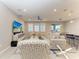 Comfortable living area with stylish seating, modern decor, large windows, and view to dining space at 13228 Saw Palm Creek Trl, Lakewood Ranch, FL 34211