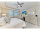 Spacious main bedroom with ceiling fan and large windows providing ample natural light at 13228 Saw Palm Creek Trl, Lakewood Ranch, FL 34211