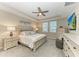 Elegant main bedroom boasts plush carpeting, tray ceiling, and abundant natural light at 13228 Saw Palm Creek Trl, Lakewood Ranch, FL 34211