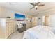Comfortable main bedroom with ceiling fan, dresser, and a view of the ensuite at 13228 Saw Palm Creek Trl, Lakewood Ranch, FL 34211