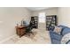Functional home office with modern desk, shelving, and comfortable seating area at 13228 Saw Palm Creek Trl, Lakewood Ranch, FL 34211