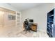 Bright office space with contemporary desk, sliding doors and convenient shelving at 13228 Saw Palm Creek Trl, Lakewood Ranch, FL 34211