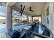 Screened-in lanai with stylish seating, ceiling fans, and a TV offers the perfect outdoor living space at 13228 Saw Palm Creek Trl, Lakewood Ranch, FL 34211