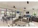 Inviting outdoor lounge area with stylish seating, ceiling fans, and seamless indoor-outdoor flow for entertaining at 13228 Saw Palm Creek Trl, Lakewood Ranch, FL 34211