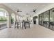 Elegant covered patio with comfortable seating, ceiling fans, and tiled floors, perfect for outdoor relaxation at 13228 Saw Palm Creek Trl, Lakewood Ranch, FL 34211