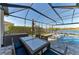 Relax and dine outdoors on the screened lanai with a view of the pool, spa, and lake at 13228 Saw Palm Creek Trl, Lakewood Ranch, FL 34211