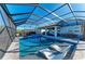 The screened lanai offers a swimming pool, spa, an outdoor kitchen, and dining, perfect for entertaining at 13228 Saw Palm Creek Trl, Lakewood Ranch, FL 34211