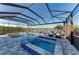 The screened lanai has a swimming pool, spa, outdoor seating, and peaceful lake views at 13228 Saw Palm Creek Trl, Lakewood Ranch, FL 34211