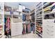 Custom walk-in closet offers ample storage, shelving, and hanging space for organization at 13228 Saw Palm Creek Trl, Lakewood Ranch, FL 34211