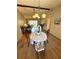 Open-concept dining area with seating for four and views of the living room and screened-in lanai at 1412 56Th W St # 1412, Bradenton, FL 34209