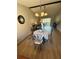 Dining area adjacent to the living room features a round table with four chairs and overhead lighting at 1412 56Th W St # 1412, Bradenton, FL 34209