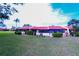 Beautiful villa exterior highlighting well-kept landscaping, screened porch, and ample lawn space at 1412 56Th W St # 1412, Bradenton, FL 34209