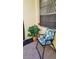 Relaxing front porch sitting area with a cozy chair and vibrant plant accents at 1412 56Th W St # 1412, Bradenton, FL 34209