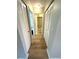 Hallway with new flooring and access to multiple rooms, including the bathroom with a walk-in shower at 1412 56Th W St # 1412, Bradenton, FL 34209