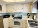 Cozy kitchen featuring white countertops and cabinetry, complemented by white appliances and ample natural light at 1412 56Th W St # 1412, Bradenton, FL 34209