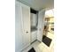 Convenient laundry closet with a stacked washer and dryer unit, situated near the kitchen at 1412 56Th W St # 1412, Bradenton, FL 34209