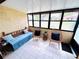 View of the enclosed lanai with daybed and chairs at 1412 56Th W St # 1412, Bradenton, FL 34209
