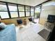 Enclosed lanai with comfortable seating and tiled floors at 1412 56Th W St # 1412, Bradenton, FL 34209
