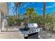 Backyard with grill and tropical landscaping at 150 Crescent Dr, Anna Maria, FL 34216