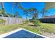 Fenced yard with trees and grass showing the home's outdoor green space at 1550 Royal Rd, Venice, FL 34293