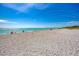 Wide sandy beach with tranquil turquoise waters providing a serene and picturesque coastal setting at 1550 Royal Rd, Venice, FL 34293