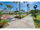 Beautiful street view featuring shops, lush landscaping, and palm trees on a sunny day at 1550 Royal Rd, Venice, FL 34293