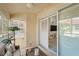 View of the covered and screened lanai with comfortable seating and ceiling fan at 203 Casa Del Lago Way # 203, Venice, FL 34292