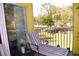 Serene screened-in balcony with a comfortable lounge chair and nature scenery at 2060 Willow Hammock Cir # 201, Punta Gorda, FL 33983