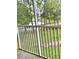 A balcony view overlooking the green space and a pond surrounded by trees with a walking path at 2060 Willow Hammock Cir # 201, Punta Gorda, FL 33983