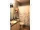 Bathroom featuring a sink, toilet, and patterned shower curtain; neutral color palette at 2060 Willow Hammock Cir # 201, Punta Gorda, FL 33983