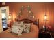 Cozy bedroom featuring decorative pillows, unique wall decor and soft bedside lighting at 2060 Willow Hammock Cir # 201, Punta Gorda, FL 33983