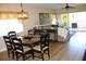 Open-concept dining area with a round table and chandelier, flowing into the living room at 2060 Willow Hammock Cir # 201, Punta Gorda, FL 33983