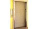 Elevator with button panel inside a yellow building at 2060 Willow Hammock Cir # 201, Punta Gorda, FL 33983