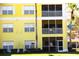 Close-up view of the exterior of the yellow condo building featuring screened lanais at 2060 Willow Hammock Cir # 201, Punta Gorda, FL 33983