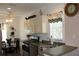 Bright kitchen features stainless steel appliances and adjacent breakfast area with a ceiling fan at 2060 Willow Hammock Cir # 201, Punta Gorda, FL 33983