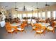 Spacious recreation room with multiple dining tables, ceiling fans and ample natural light at 2060 Willow Hammock Cir # 201, Punta Gorda, FL 33983