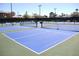 Bright blue tennis courts with nets and lights offer an active lifestyle in this community at 2060 Willow Hammock Cir # 201, Punta Gorda, FL 33983