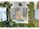Stunning aerial view of a modern home featuring a rooftop deck, pool, and meticulously landscaped grounds at 215 83Rd St, Holmes Beach, FL 34217