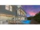 Luxury backyard featuring a pool, outdoor lounge, dining area, and bar, all under a beautiful wood-paneled ceiling at 215 83Rd St, Holmes Beach, FL 34217