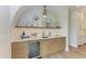 Stylish bar area features custom cabinetry, a beverage fridge, and a countertop with a sink, ideal for entertaining at 215 83Rd St, Holmes Beach, FL 34217