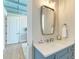 Charming bathroom featuring a blue vanity, quartz countertop, and stylish mirror at 215 83Rd St, Holmes Beach, FL 34217