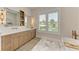 Bright bathroom featuring double sinks, modern fixtures, and a window offering natural light and views at 215 83Rd St, Holmes Beach, FL 34217