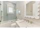 Stylish bathroom with bathtub/shower combination, light blue tile, and decorative mirror at 215 83Rd St, Holmes Beach, FL 34217
