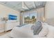 Bright primary bedroom featuring balcony access, a TV, and a calming color scheme at 215 83Rd St, Holmes Beach, FL 34217