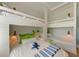 Cozy bunk room features integrated ladder, decorative pillows, and whimsical lighting at 215 83Rd St, Holmes Beach, FL 34217